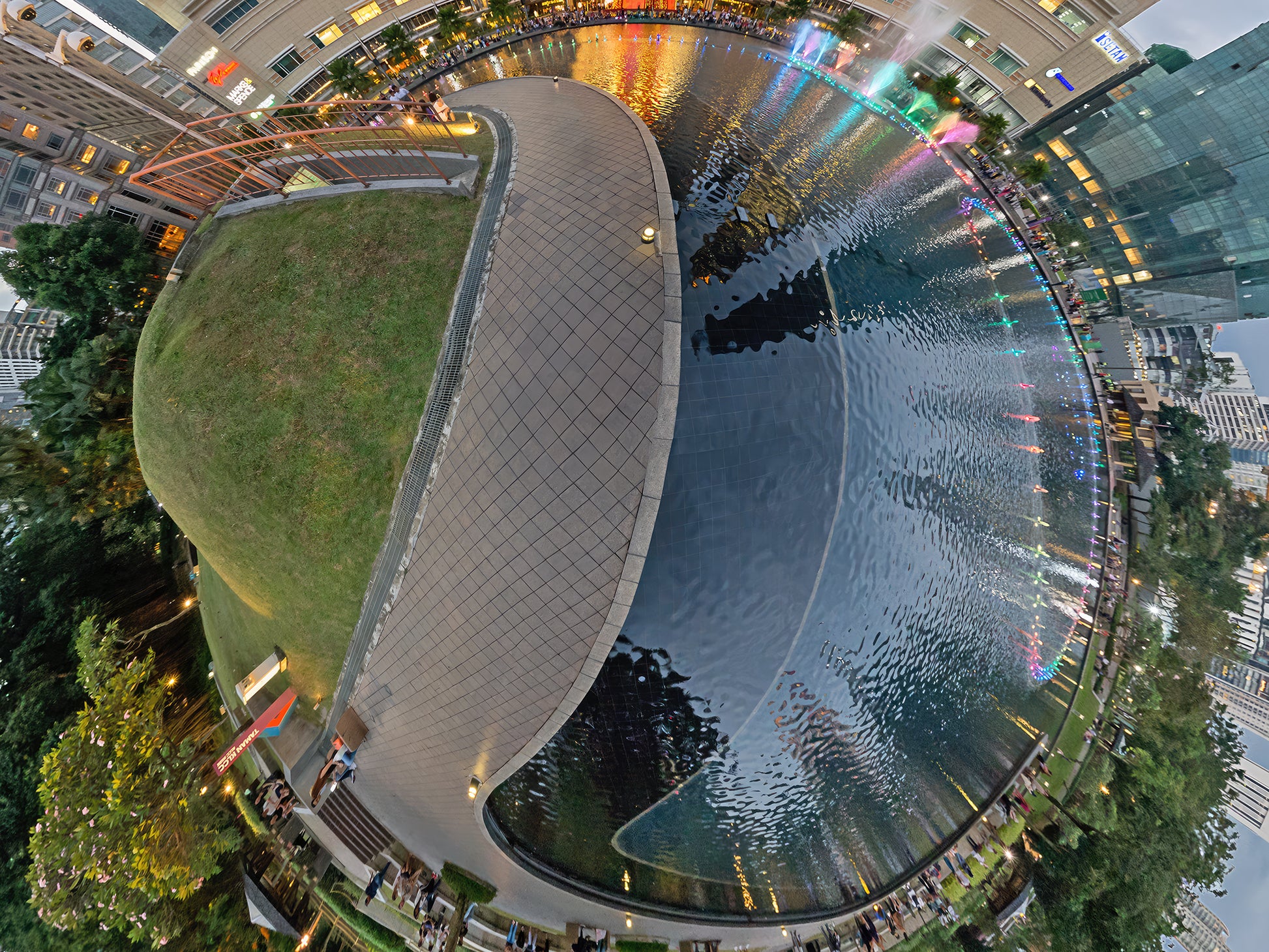 Detail 3 of Kuala Lumpur Planet, Little Big World creative fine art photography by Jean-Charles Garrivet, showing the reflecting pool, landscaped pathways and contemporary buildings around KLCC Park in Kuala Lumpur.