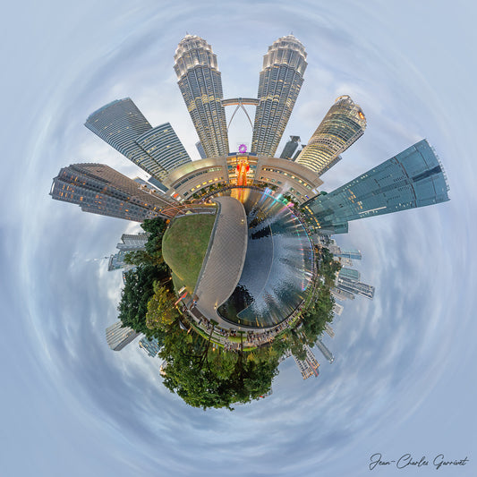 360-degree view of a cityscape with tall buildings and greenery, resembling a miniature planet.