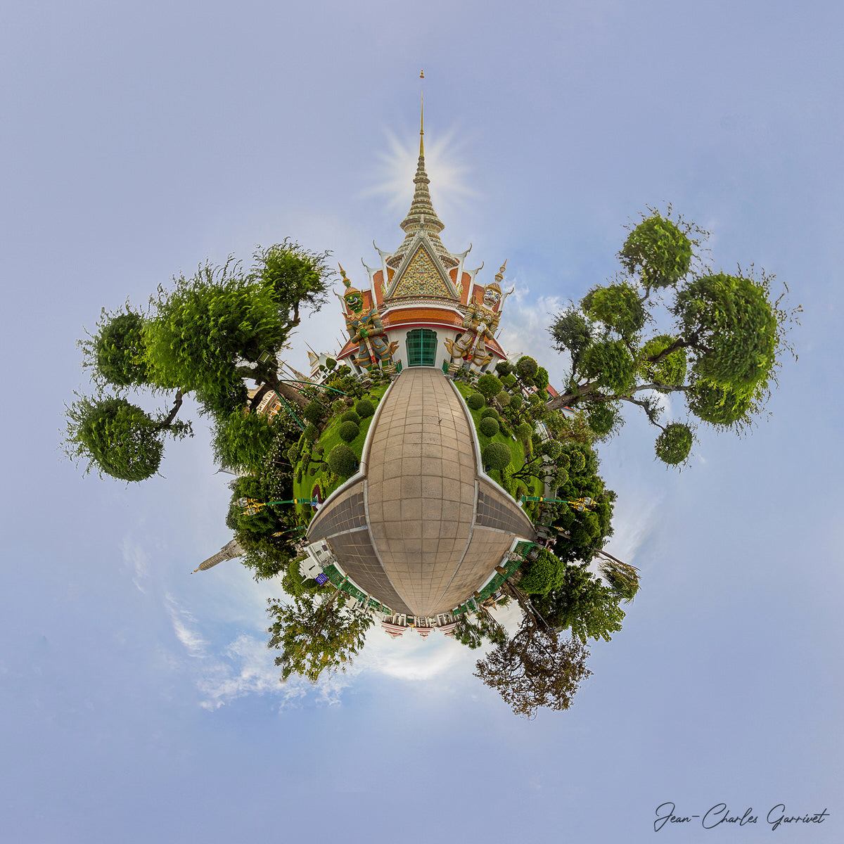 360-degree view of a temple surrounded by trees with a clear blue sky.