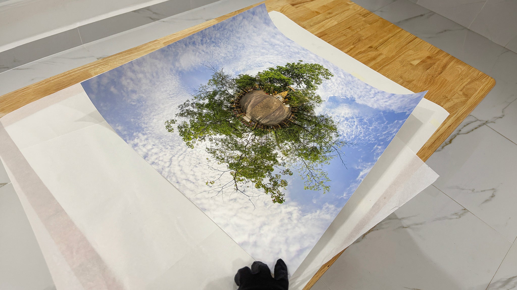 Little Big World print process by Jean-Charles Garrivet, showing the final reveal of a fine art photography print after careful unboxing and unfolding.