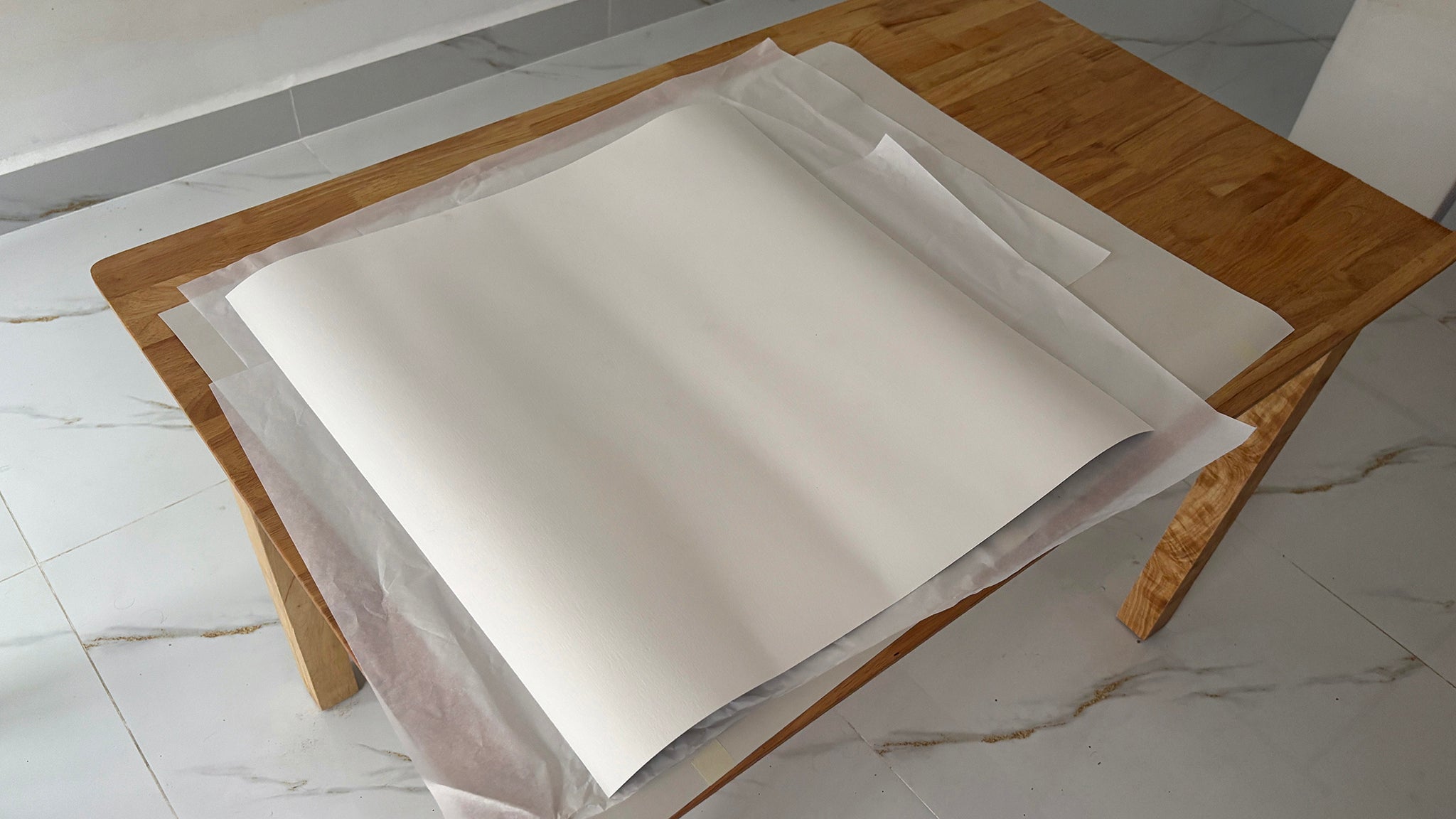 Little Big World print process by Jean-Charles Garrivet, showing the careful unfolding of a fine art photography print after unboxing.