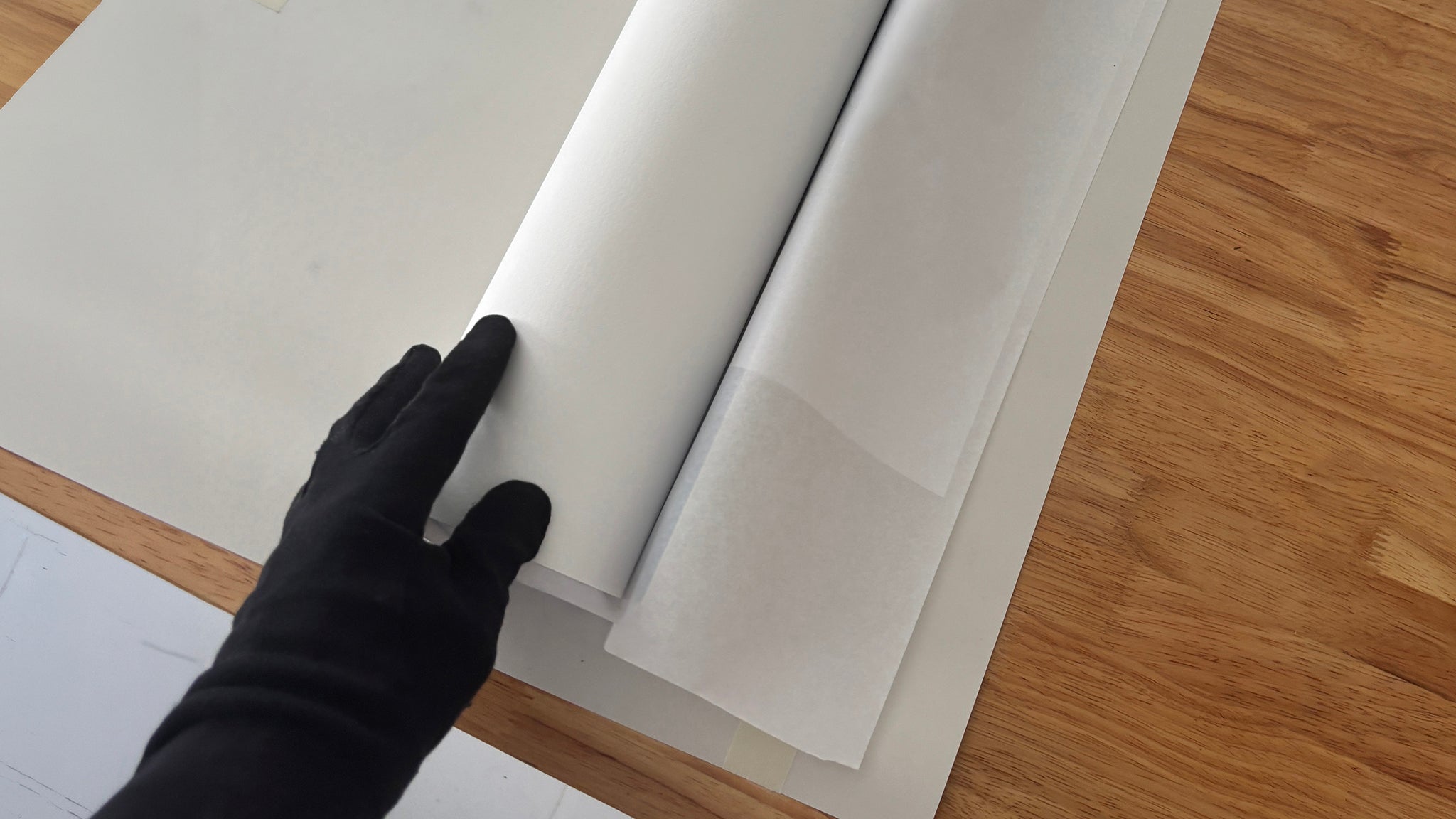 Little Big World print process by Jean-Charles Garrivet, showing how to carefully unroll a fine art photography print after opening the protective tube.